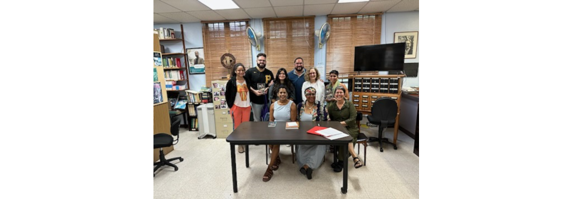 La escritora Dahlma Llanos Figueroa acompañada por la profesora Zaira Rivera, estudiantes del curso ESHI 6089 y profesores del PGT.